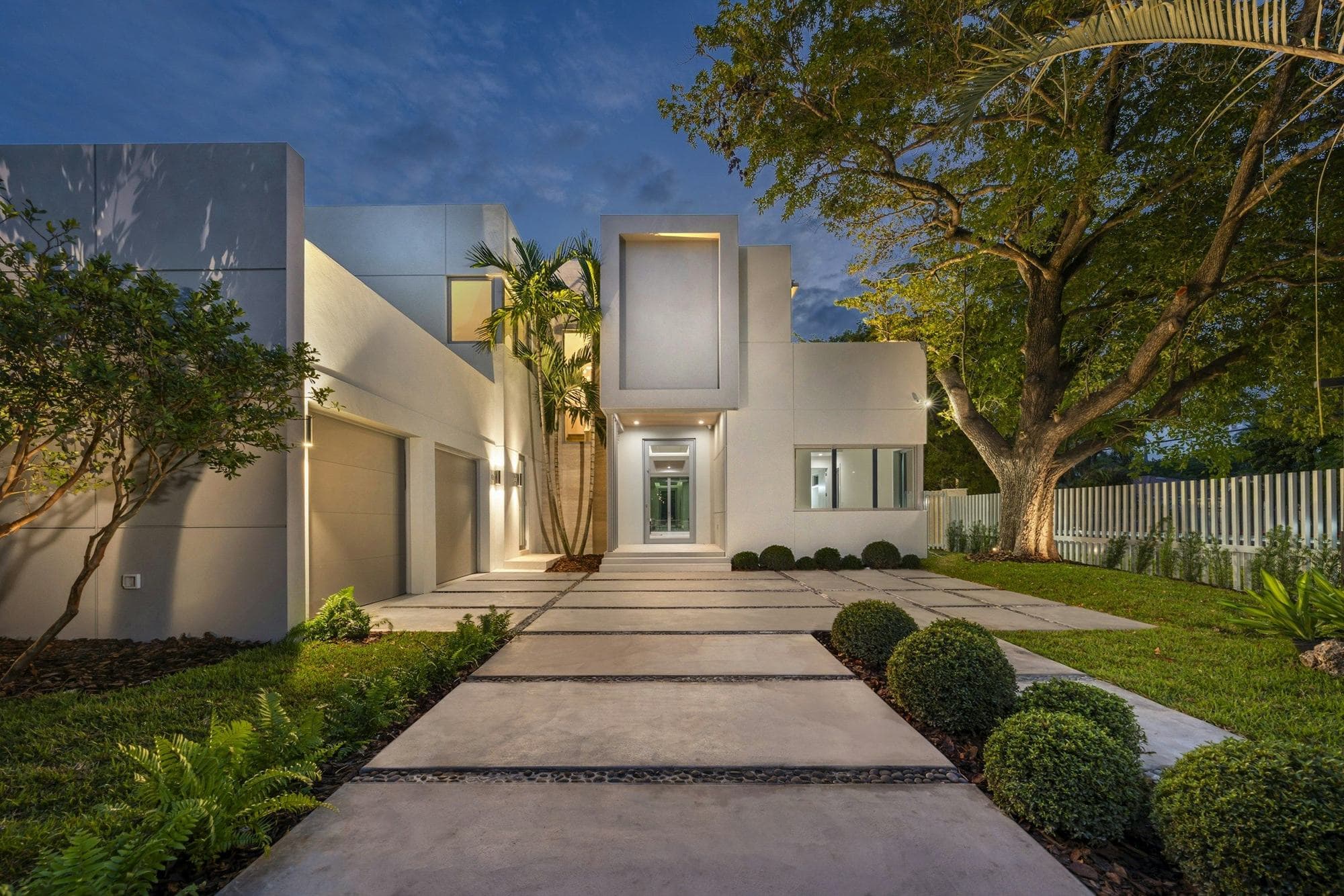Modern home lit at dusk